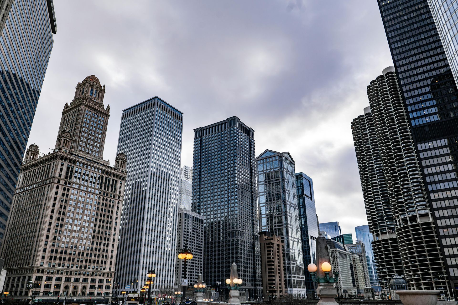 Skyscrapers against a cloudy sky in a city, possibly Chicago, viewed from below.