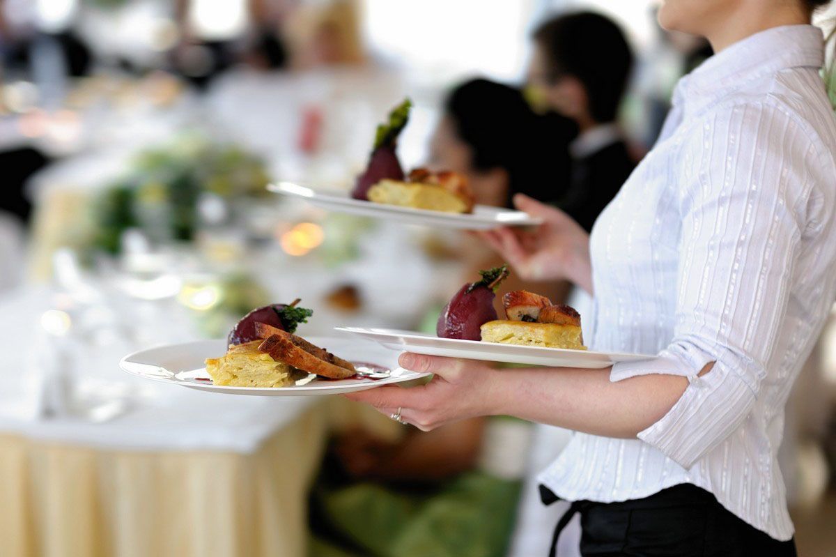 catering company servers at an event serving food