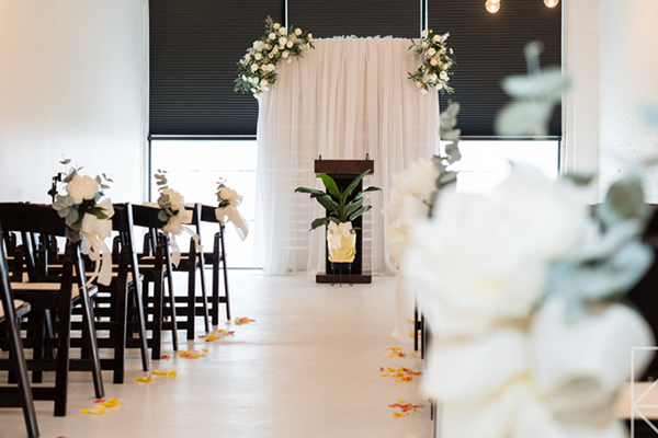 There is a podium in the middle of the room with flowers on it.