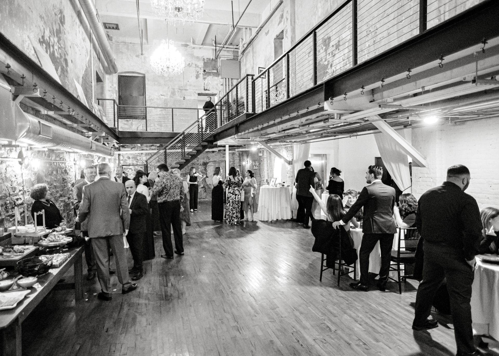 A black and white photo of a large room filled with people.