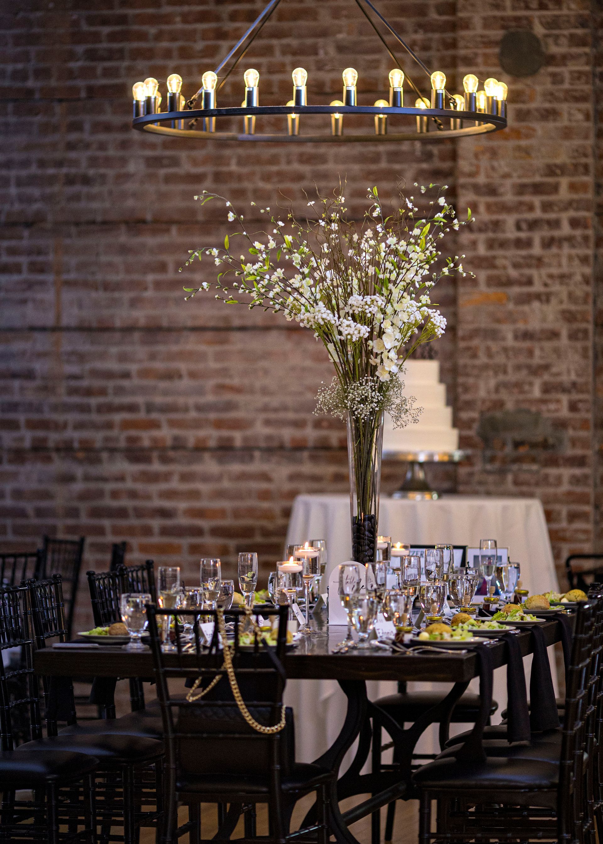 A table with lots of candles and flowers on it