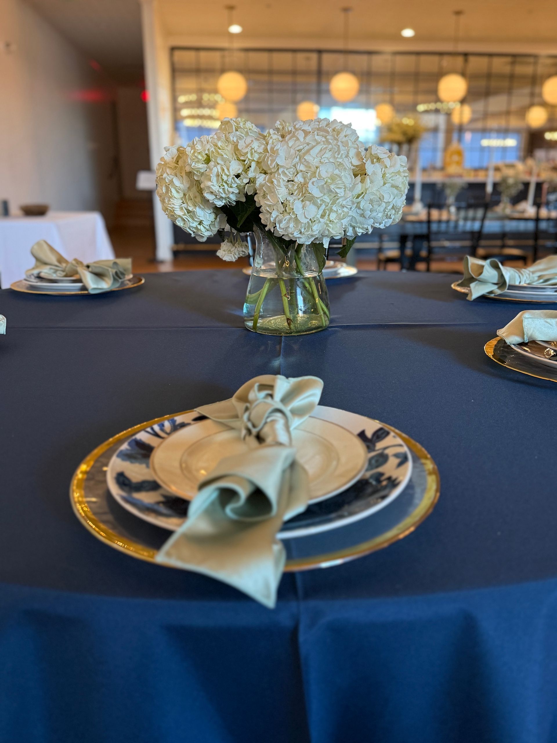 A table with plates and a vase of flowers on it