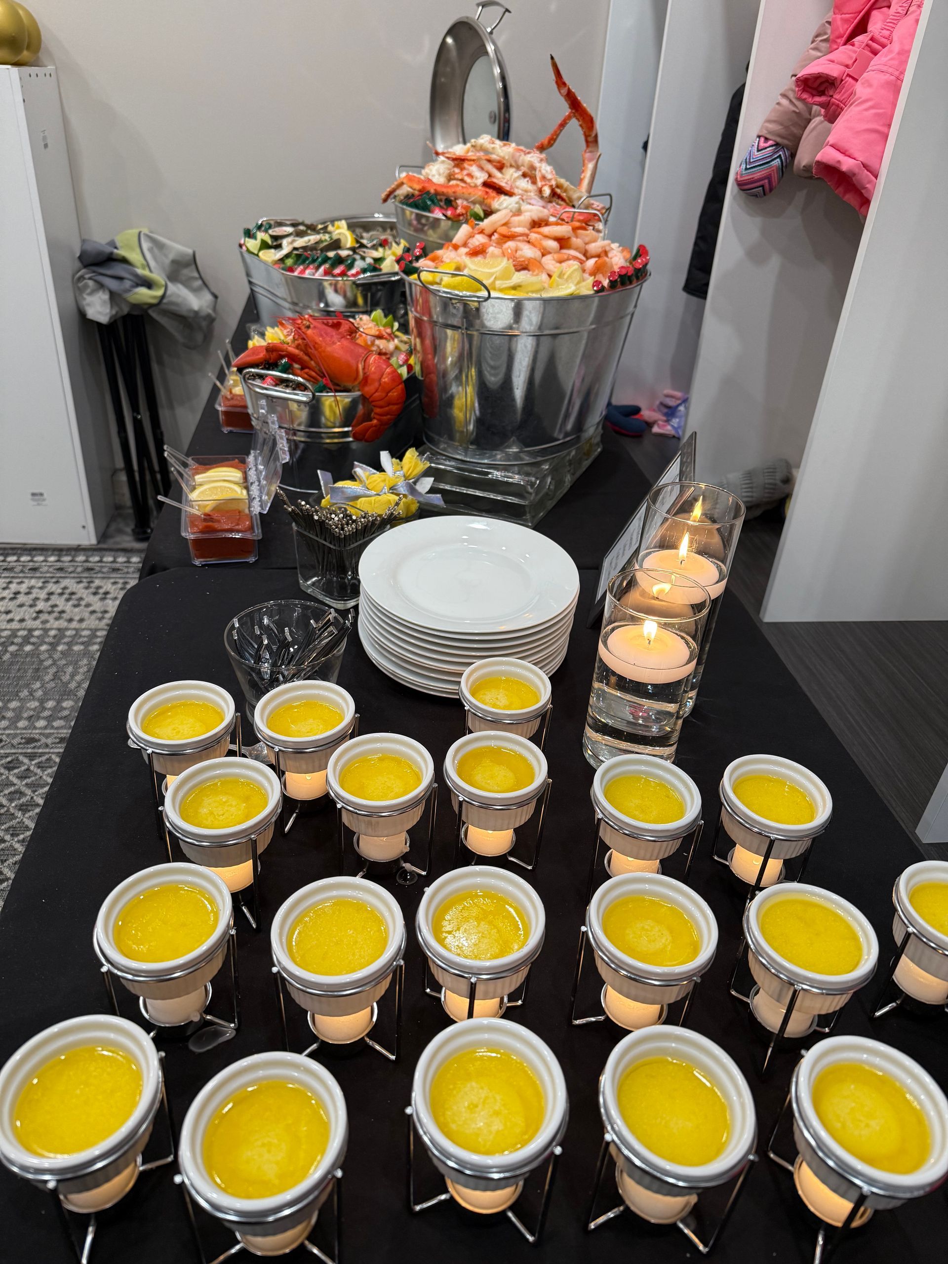 A table with a bunch of cups of yellow liquid on it