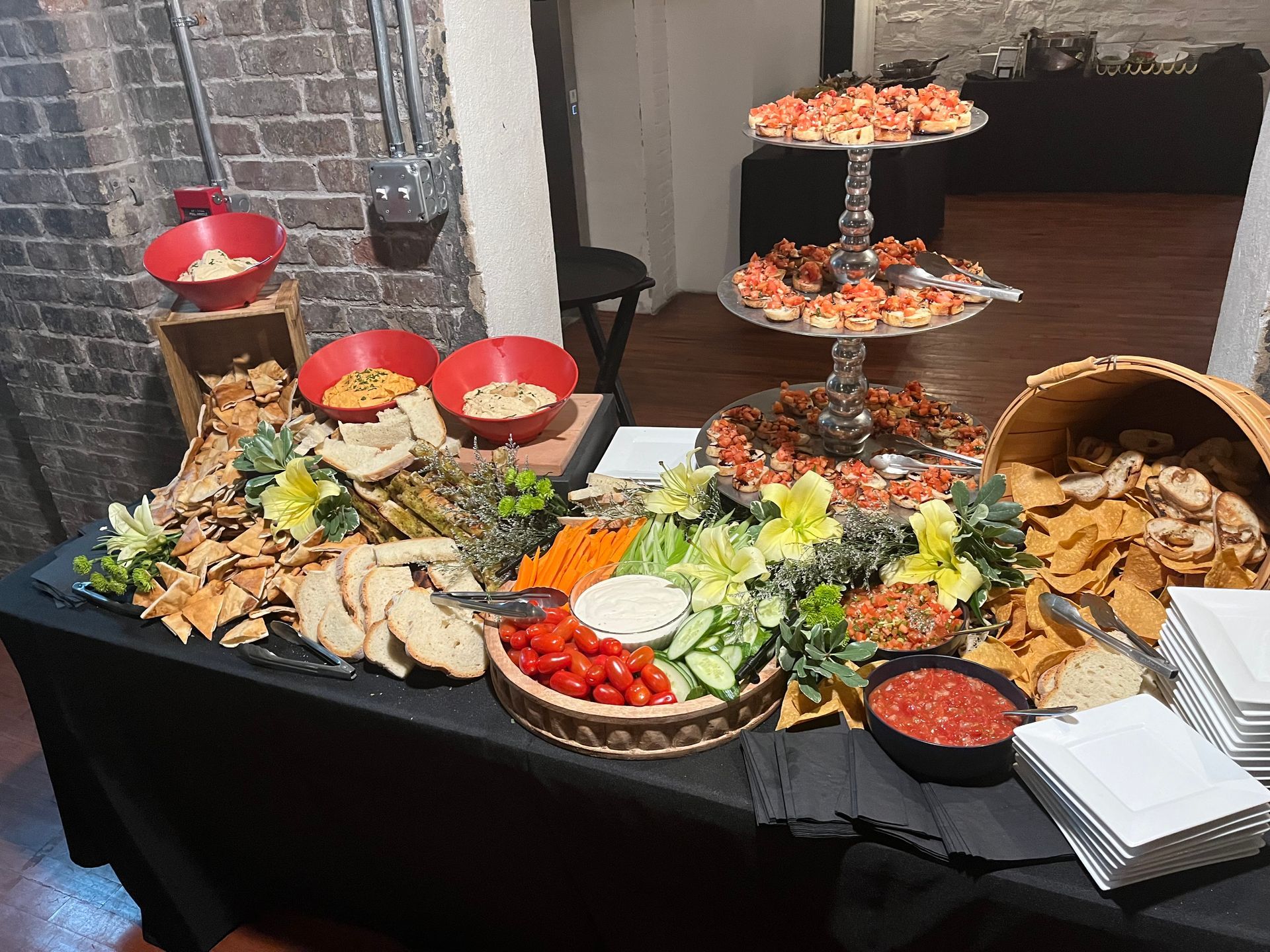 A wooden table topped with a variety of food and crackers.