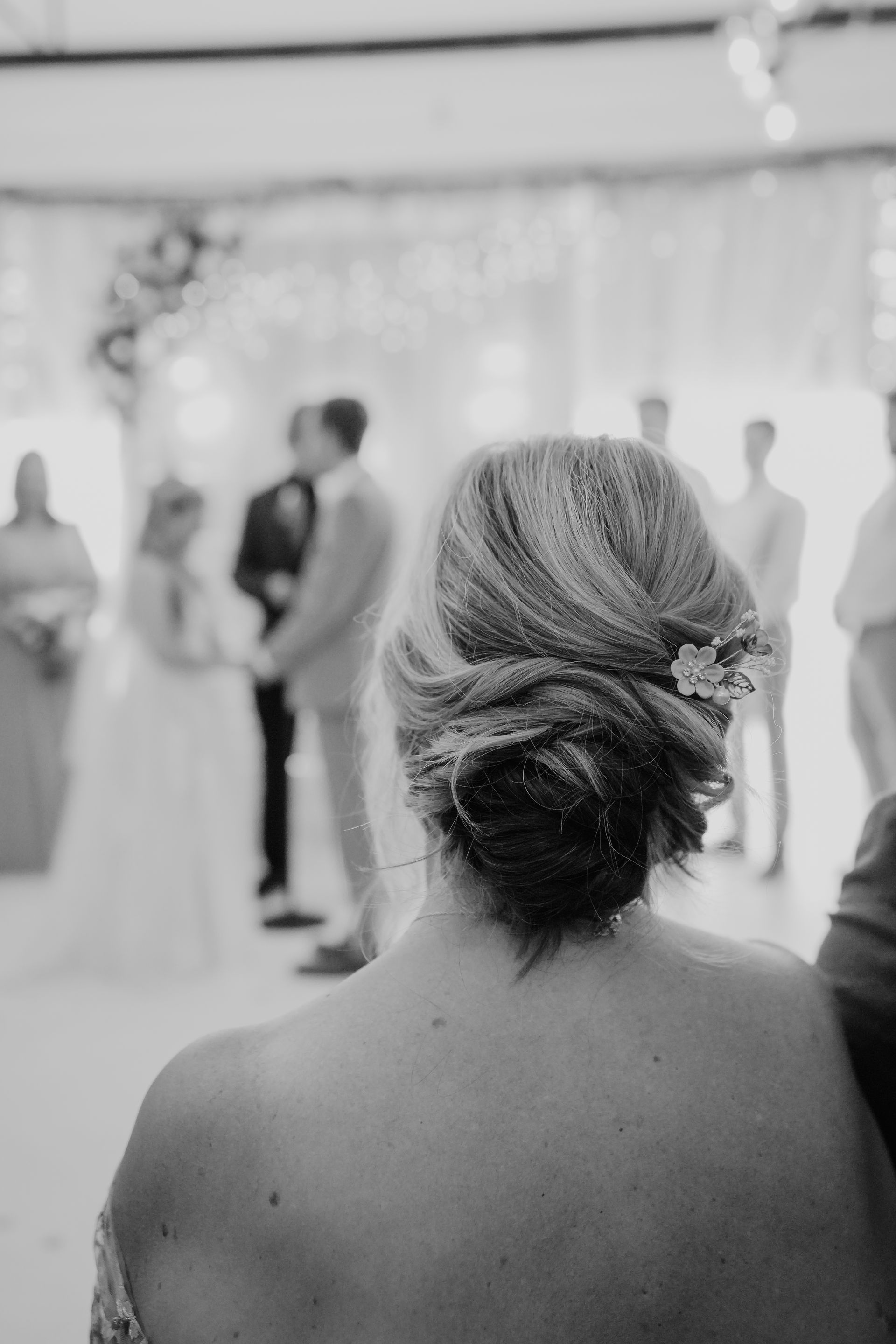 A black and white image of a wedding with a bride and groom