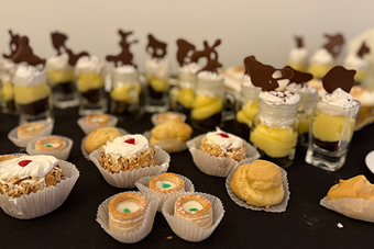 A variety of desserts are lined up on a table