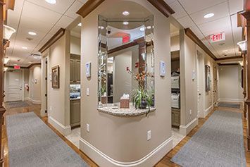 A hallway in a dental office with a counter and a window.