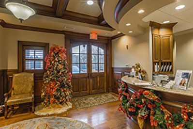 There is a christmas tree in the middle of the room.