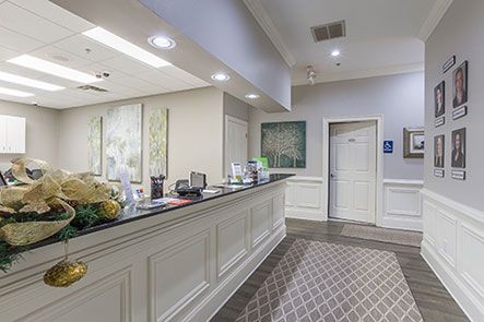 A dental office with a reception desk and a hallway.