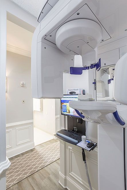 A dental office with a computer and a x-ray machine.
