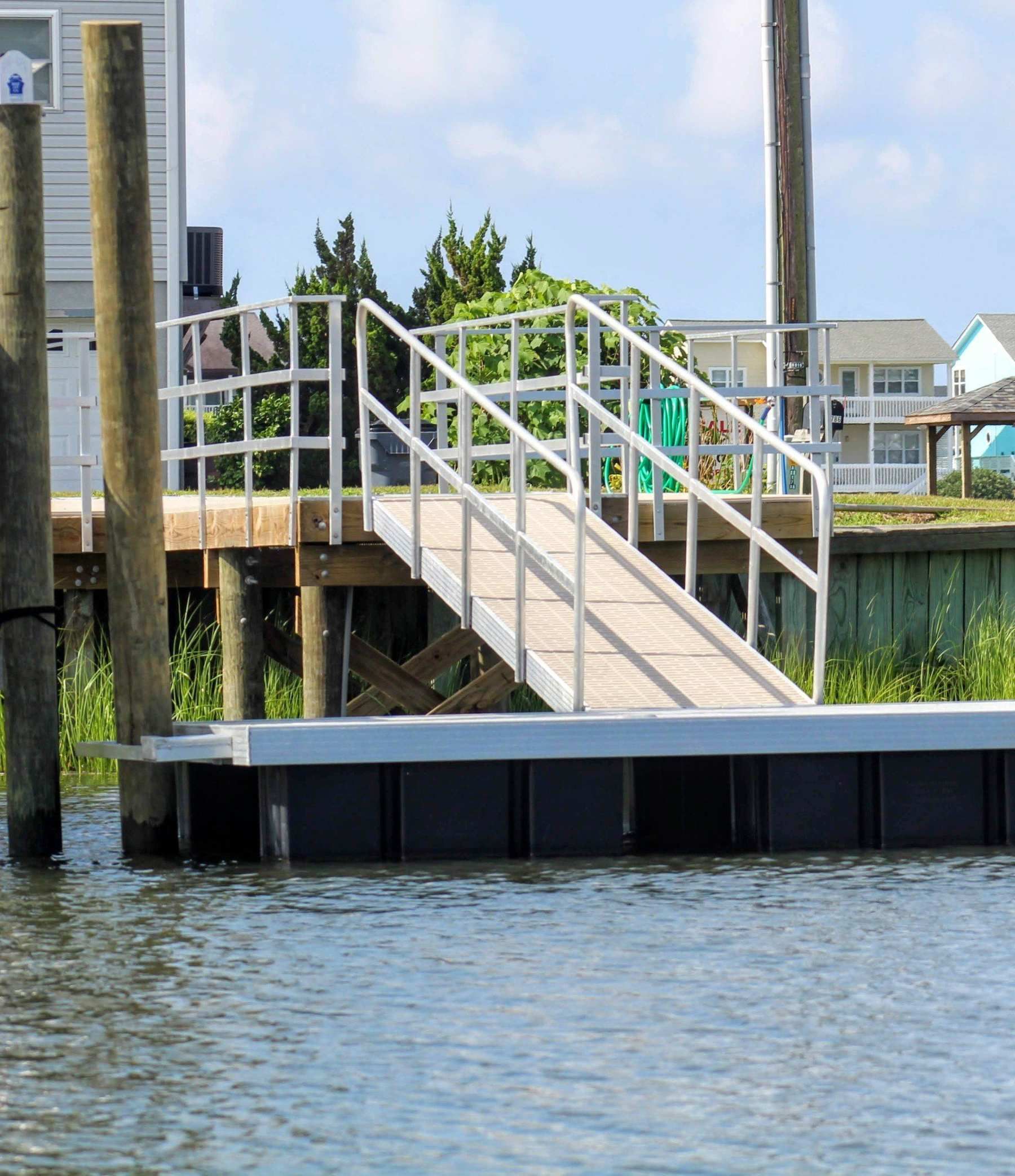 A dock with a ramp that leads to a house