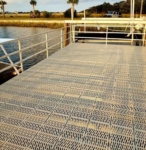 A dock with a railing overlooking a body of water