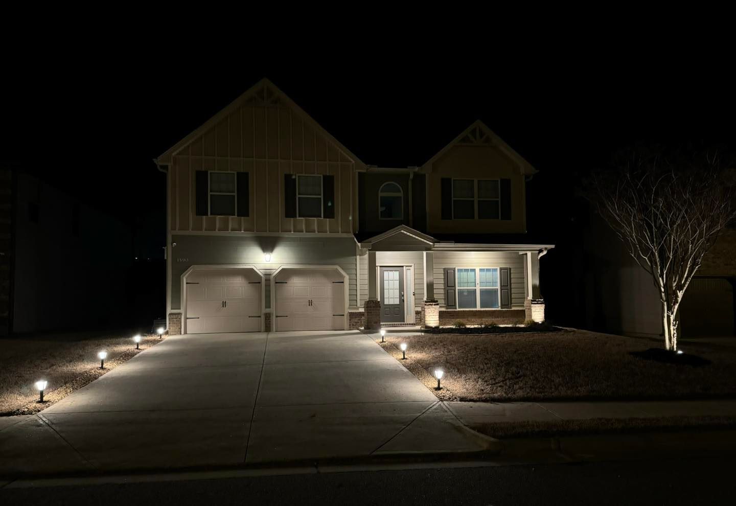 The front of a house is lit up at night