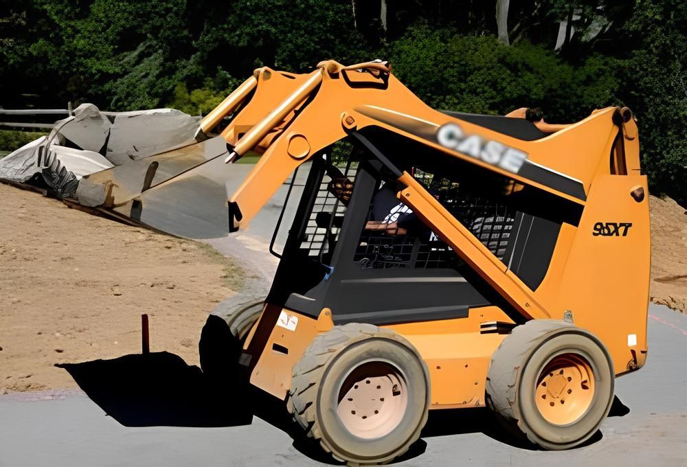 Orange Case skid steer on a construction site, scooping materials.
