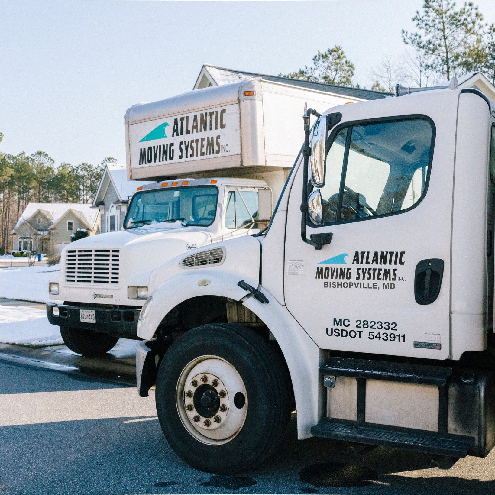 An atlantic moving systems truck is parked on the side of the road