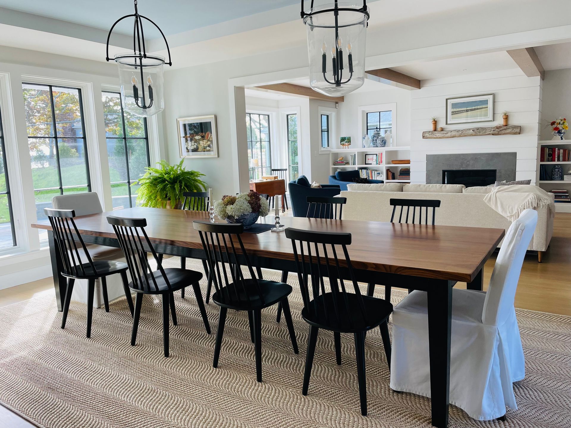 A dining room table and chairs in a living room.