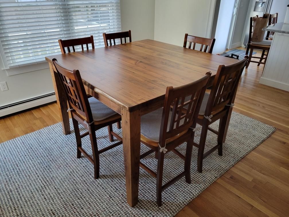 A wooden dining table and chairs in a living room.