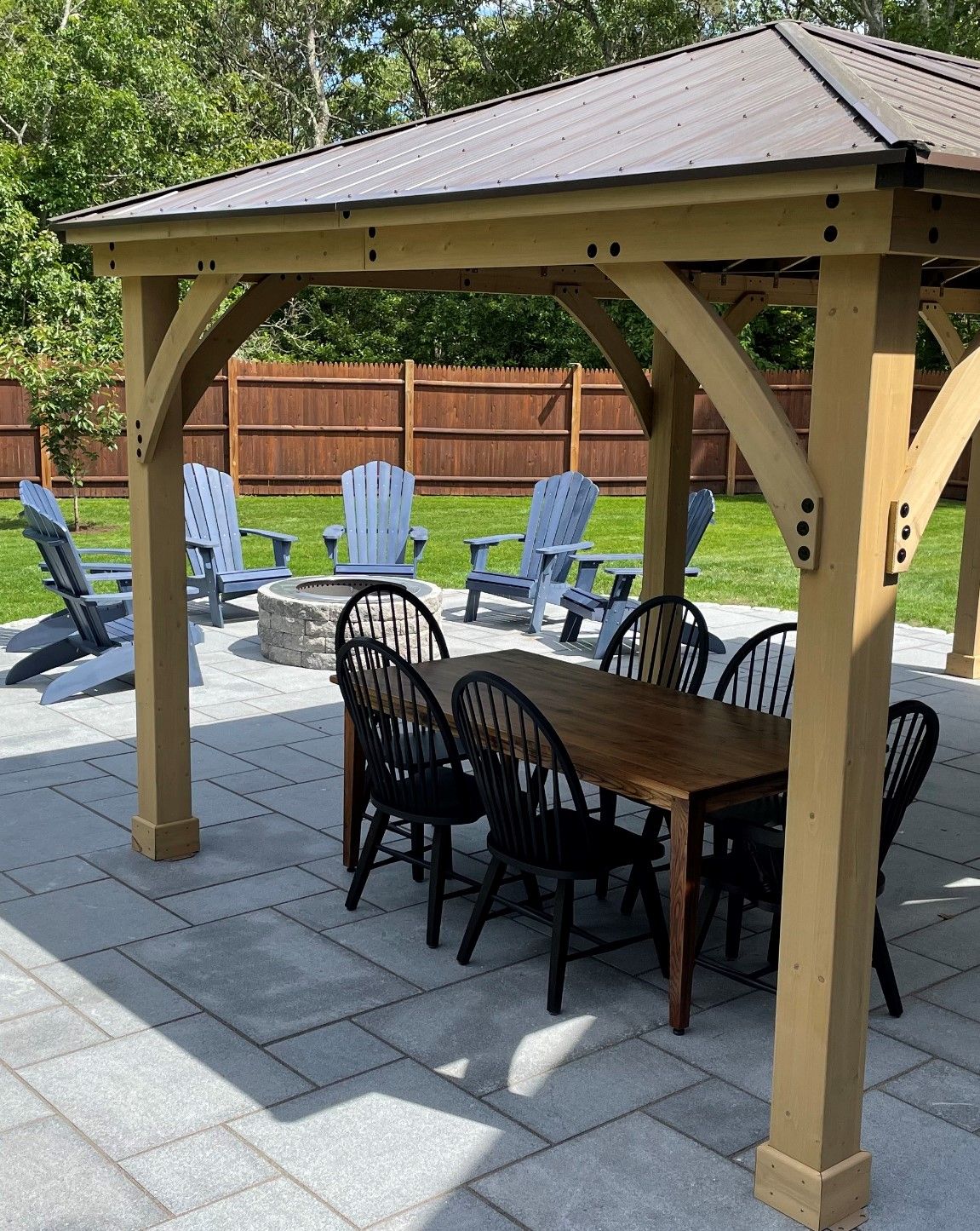 A gazebo with a table and chairs underneath it