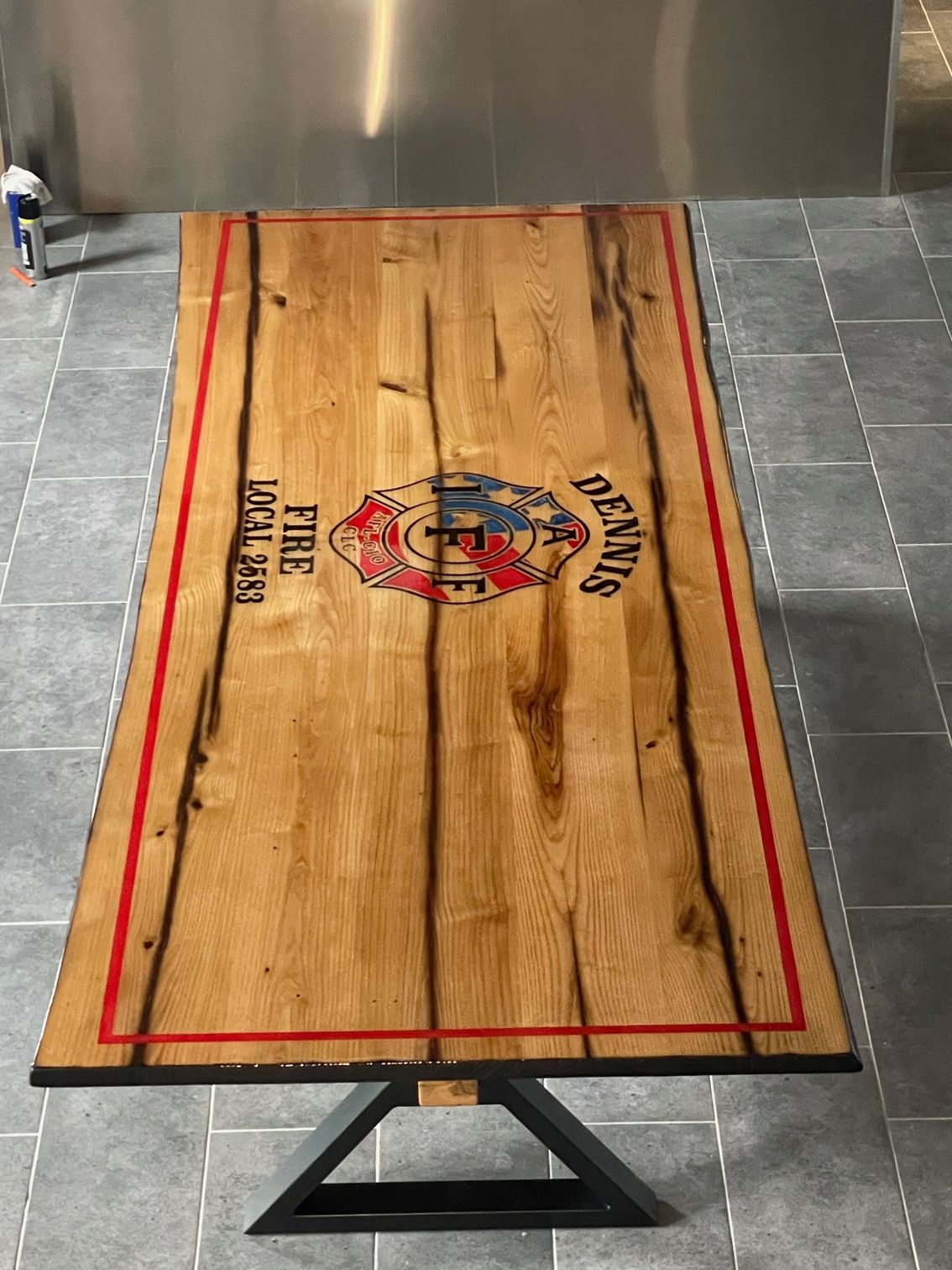 A wooden table with a fire department logo on it