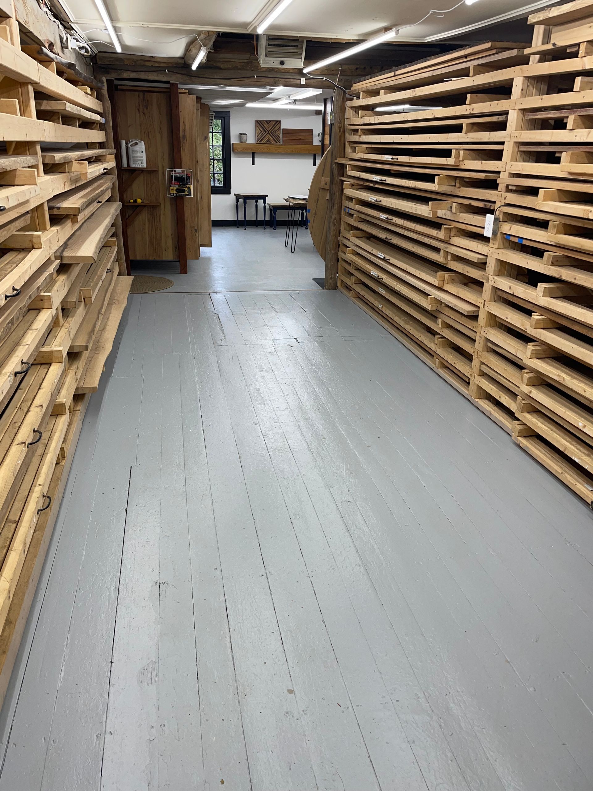 A long hallway filled with lots of wooden pallets.