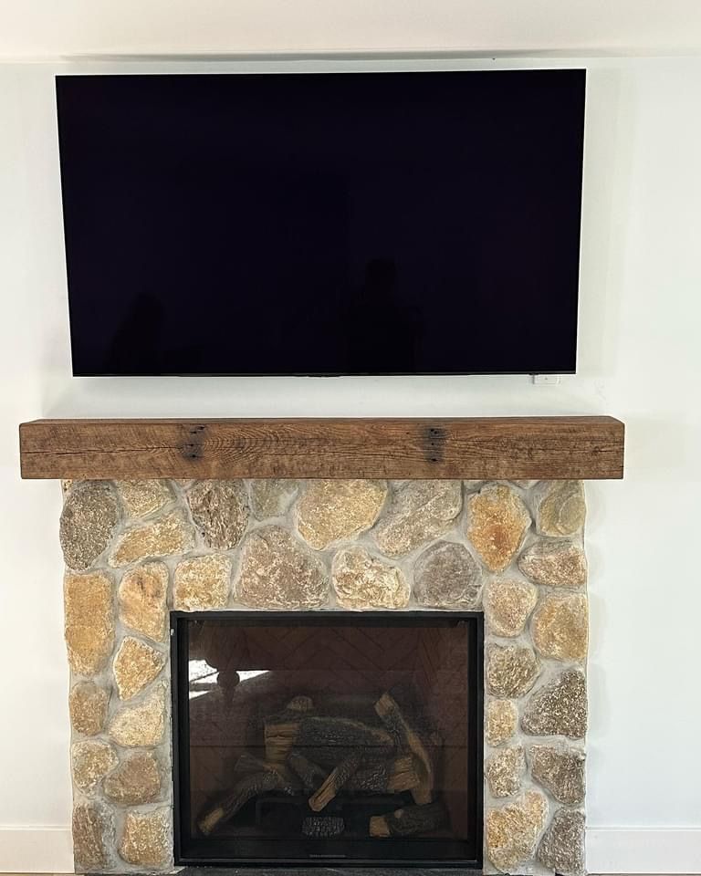 A fireplace with a flat screen tv above it