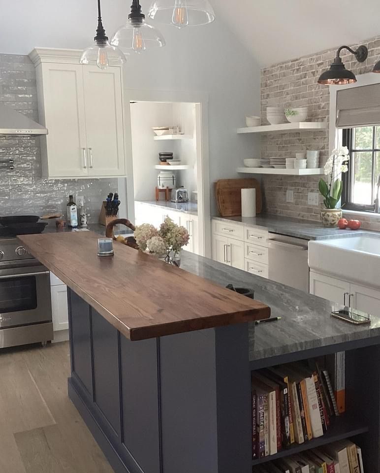 A kitchen with a large island with a wooden counter top