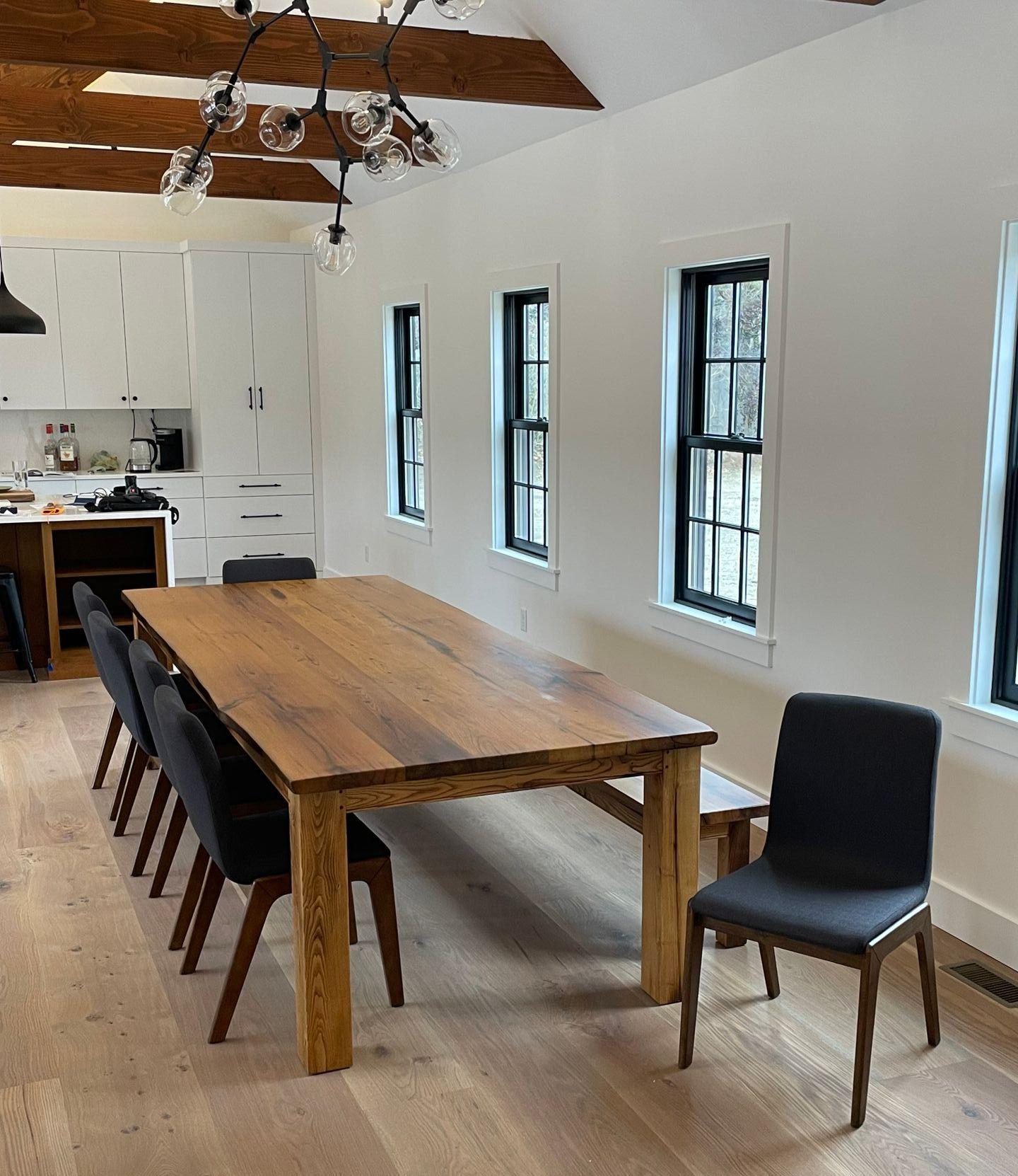 A dining room with a long wooden table and chairs