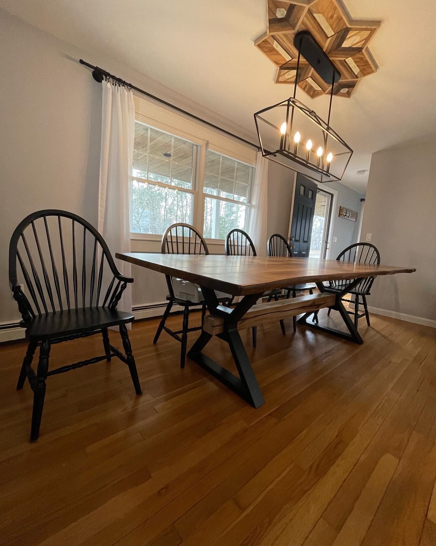 A dining room with a table and chairs and a chandelier.