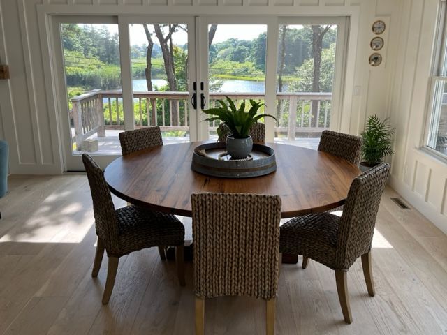 A dining room table with chairs and a plant on it