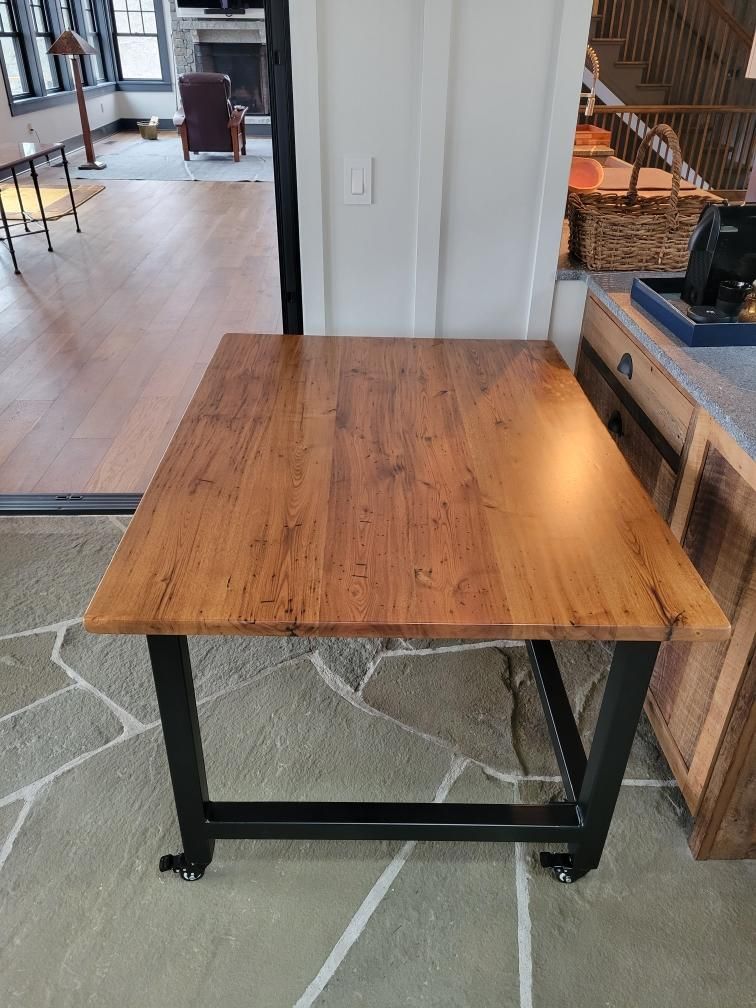 A wooden table is sitting on a tiled floor in a living room.