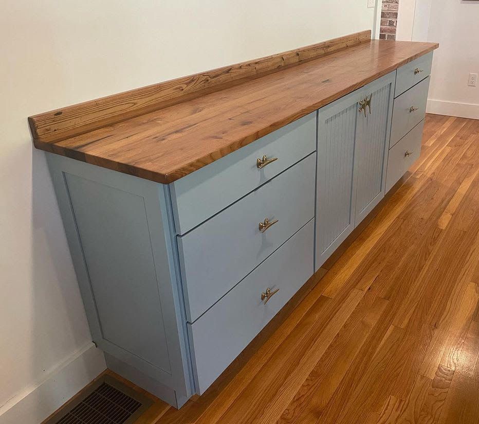 A blue cabinet with a wooden top and drawers