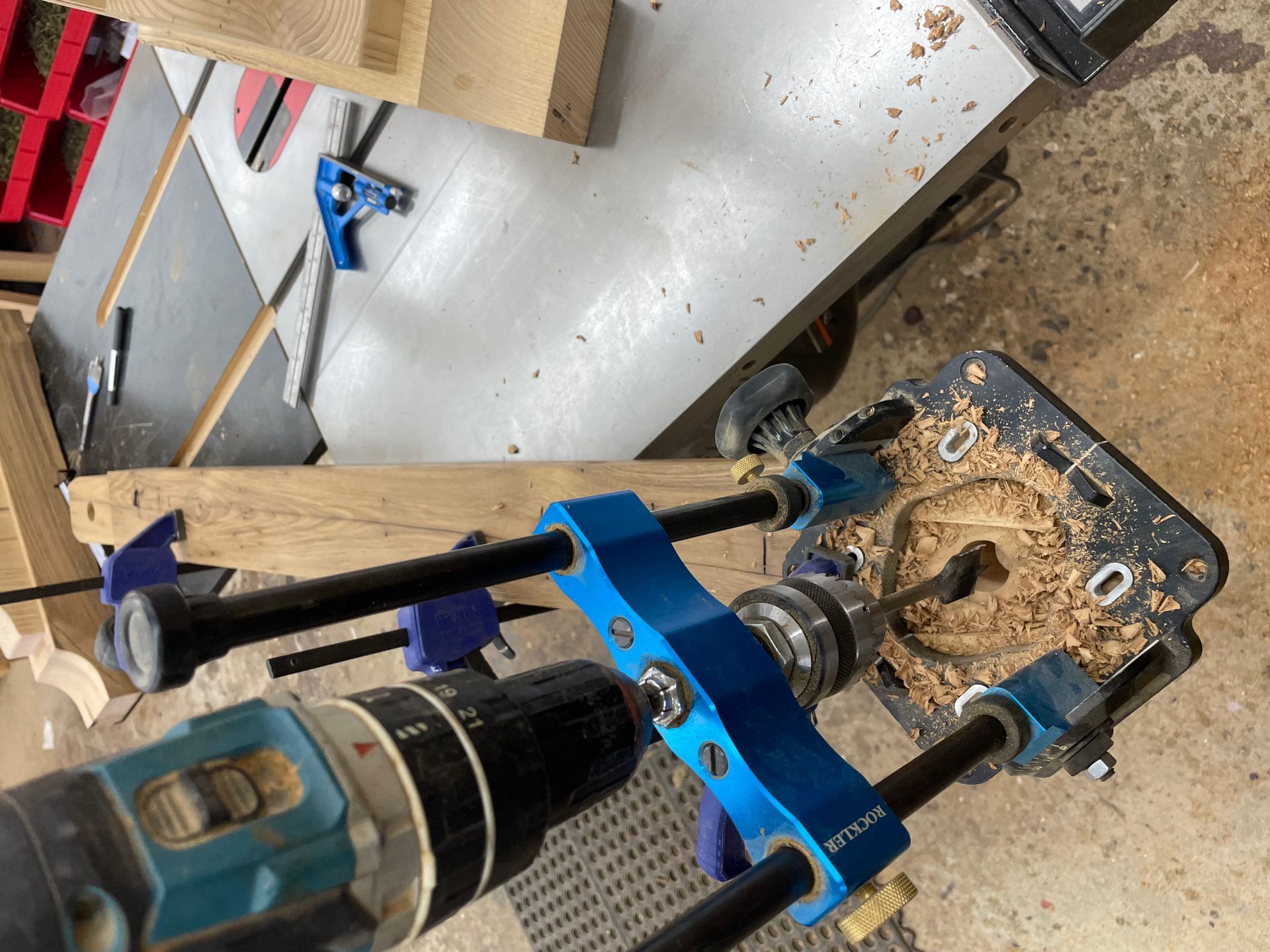 A drill is being used to make a hole in a piece of wood