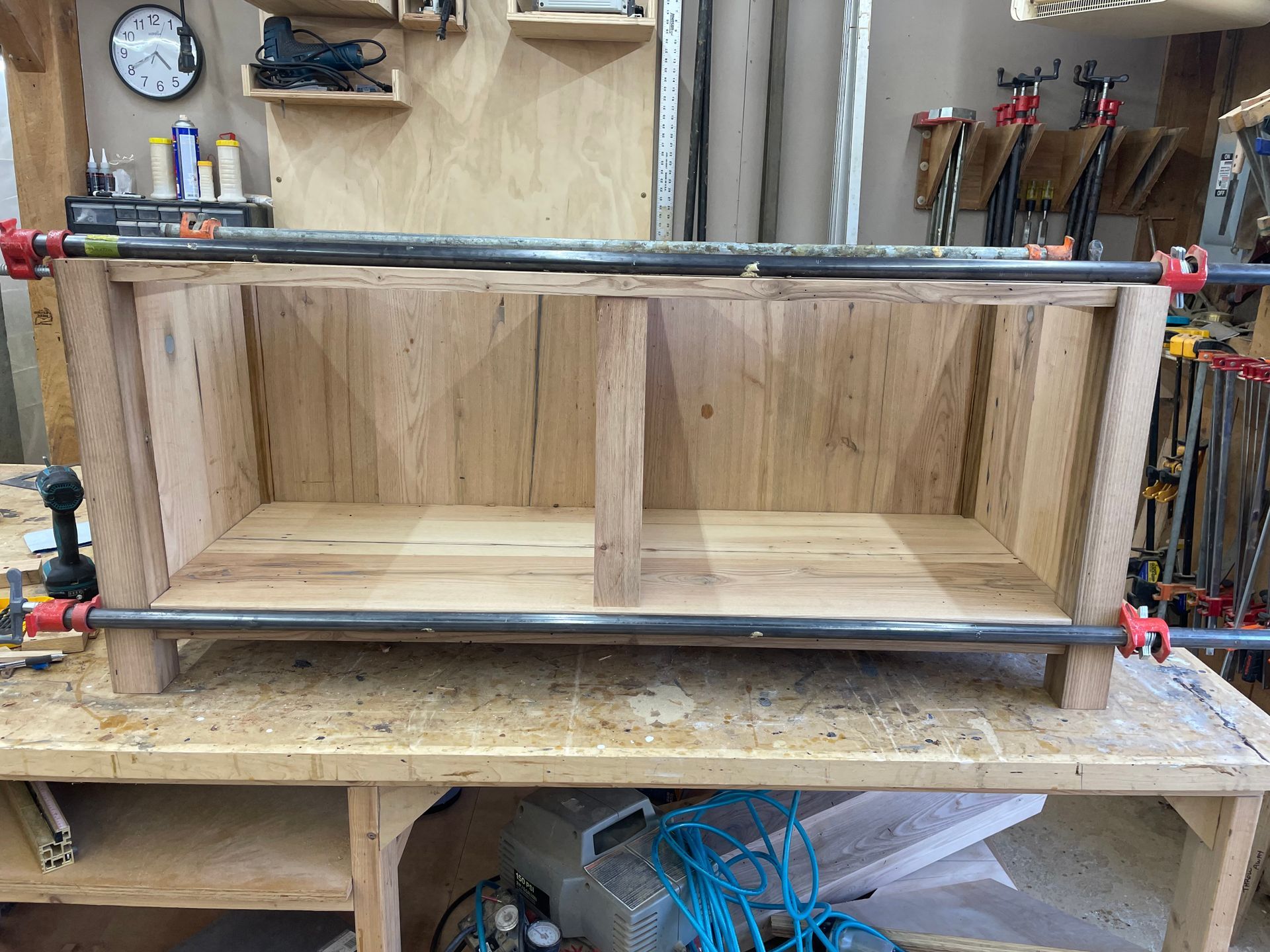 A piece of wood is sitting on top of a wooden table in a workshop.