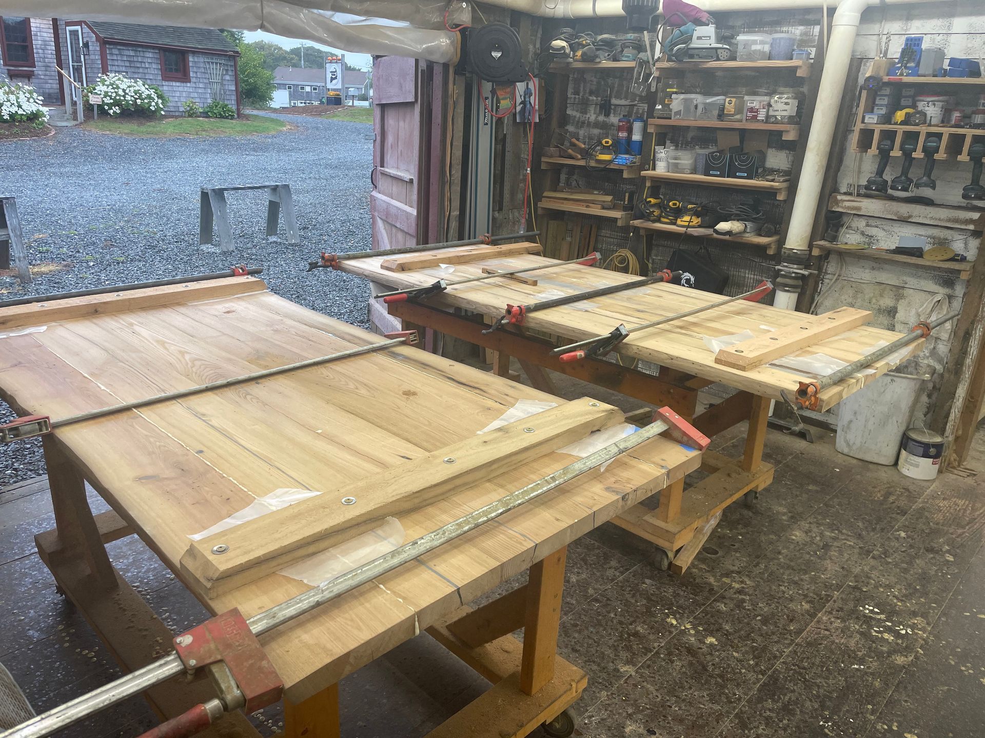 A wooden table is being glued together in a workshop.