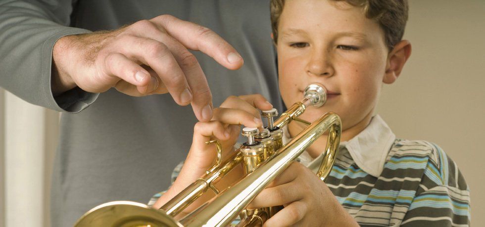 boy playing musical instrument
