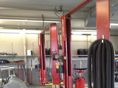 A garage with a lot of tools and a lot of lifts.