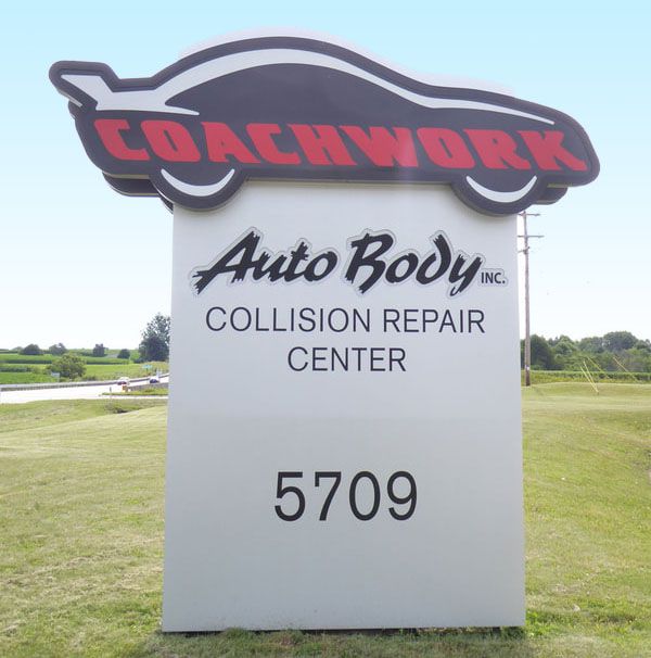 Sign for Coachwork Auto Body, a collision repair center, with address 5709.