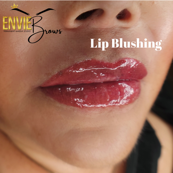 Close-up of lips with a glossy, rosy-red lip blushing treatment.