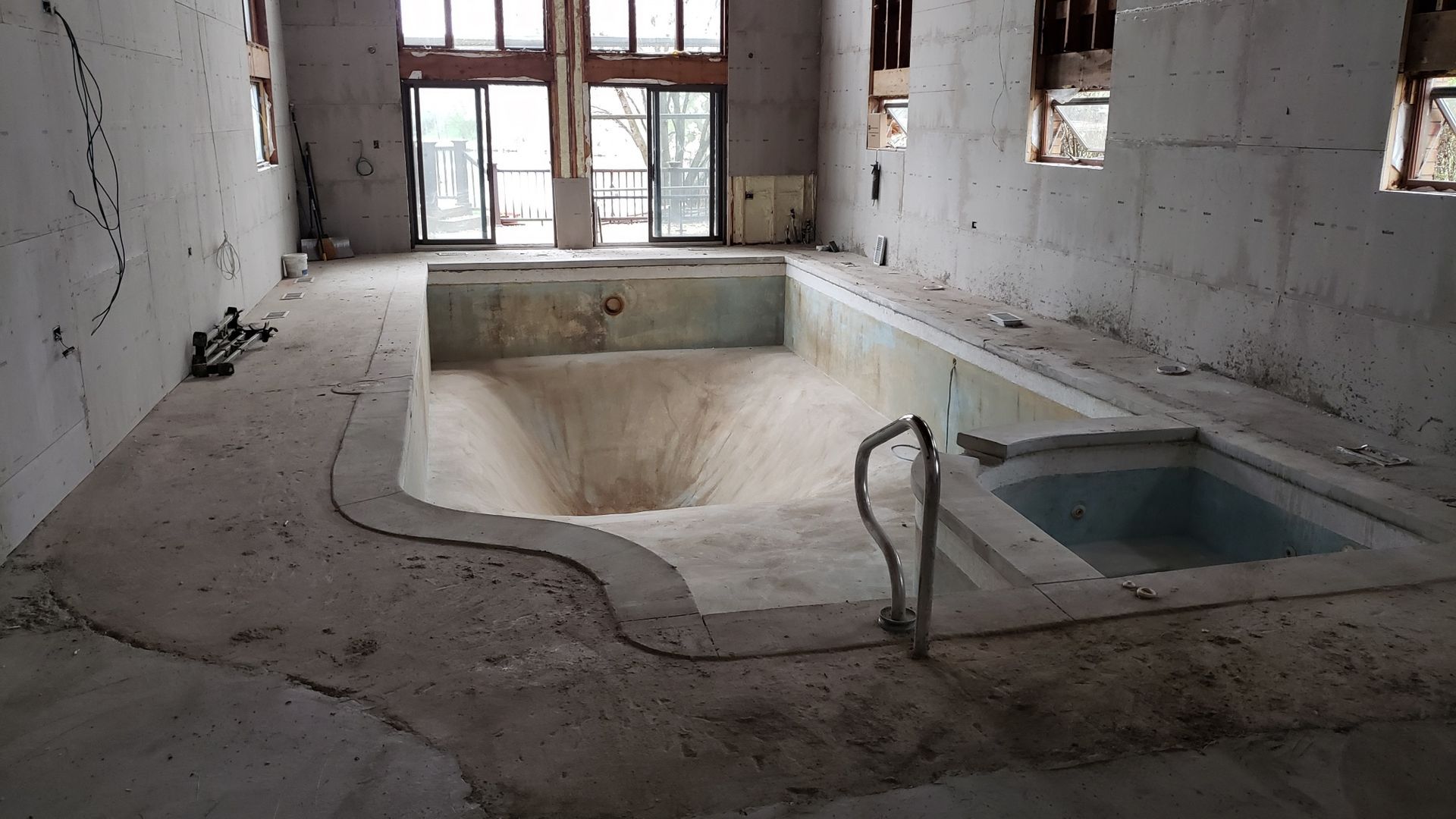 An empty swimming pool in a building under construction
