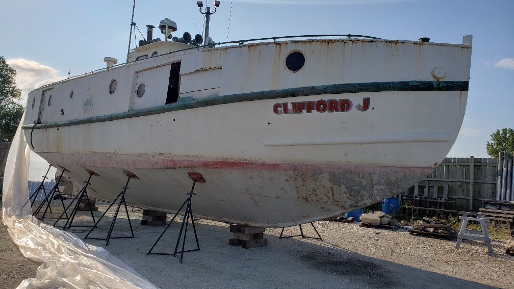 A boat with the name clifford j on it