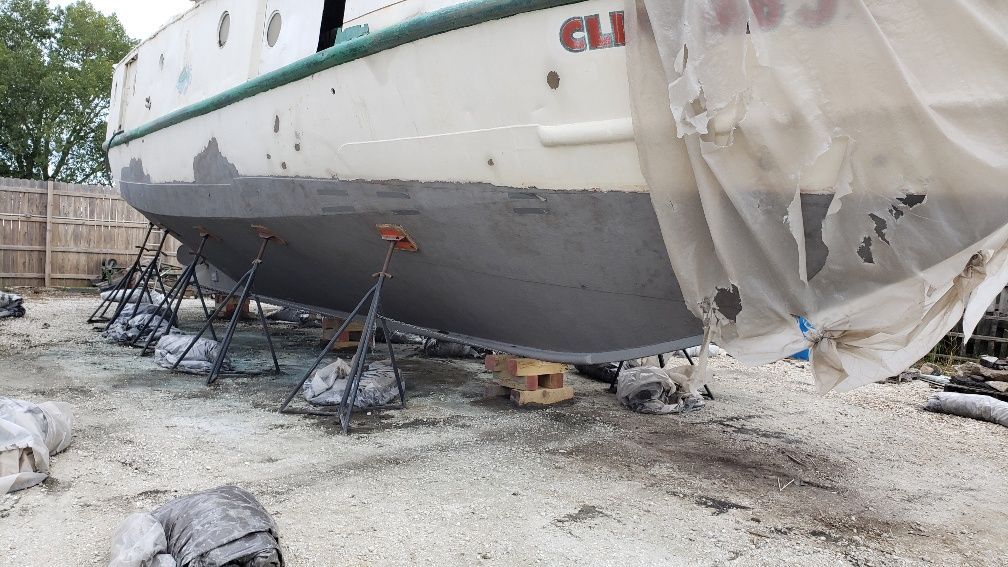 A boat with the word cli on the side is being painted