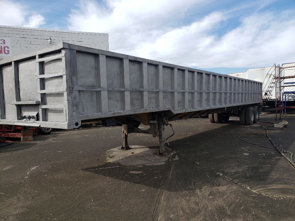 A large trailer is parked in a parking lot.