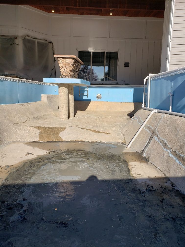A swimming pool is being remodeled in a house