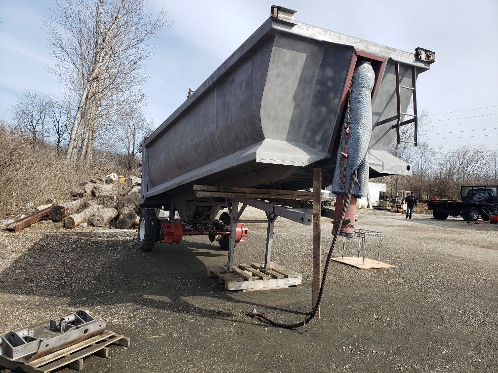 A dumpster is sitting on the ground in a parking lot.
