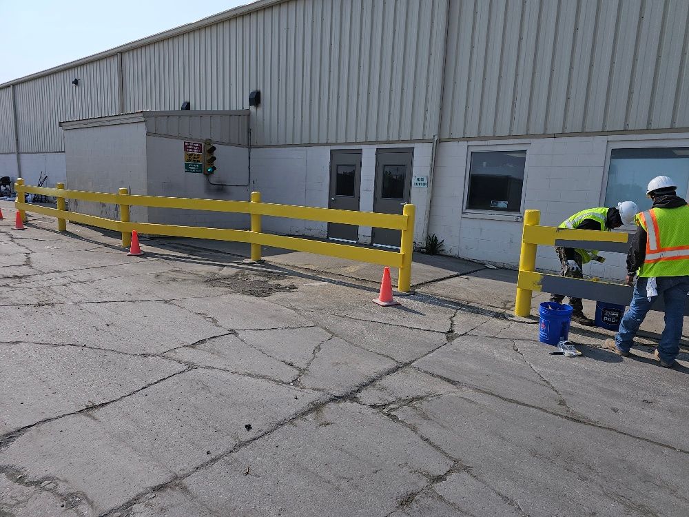 A yellow fence is being built in front of a building