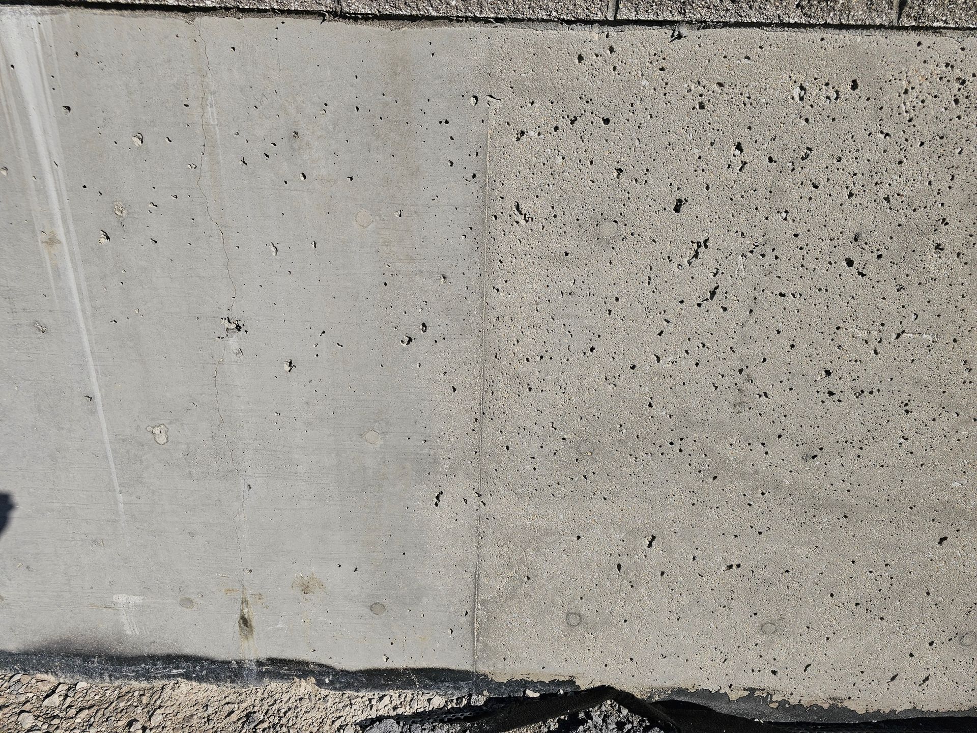 A close up of a concrete surface with a shadow on it