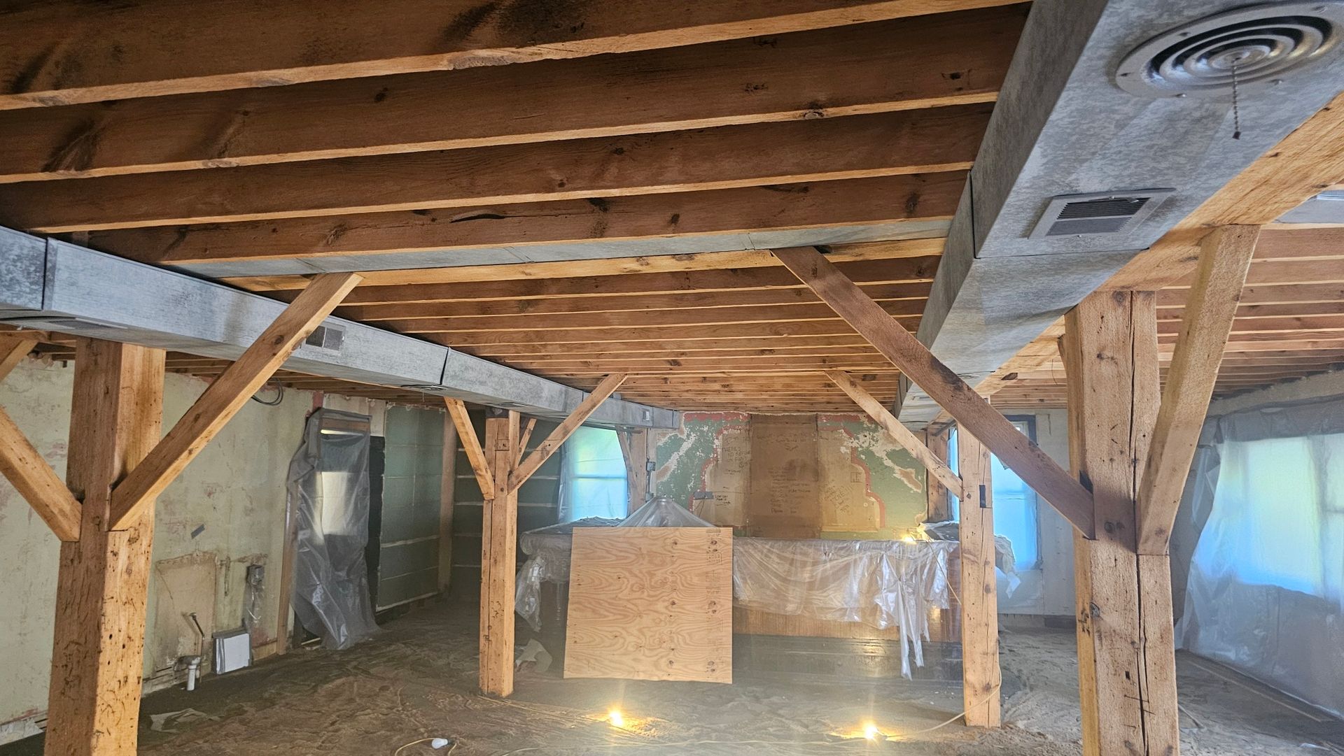 An empty room with wooden beams and a ceiling.
