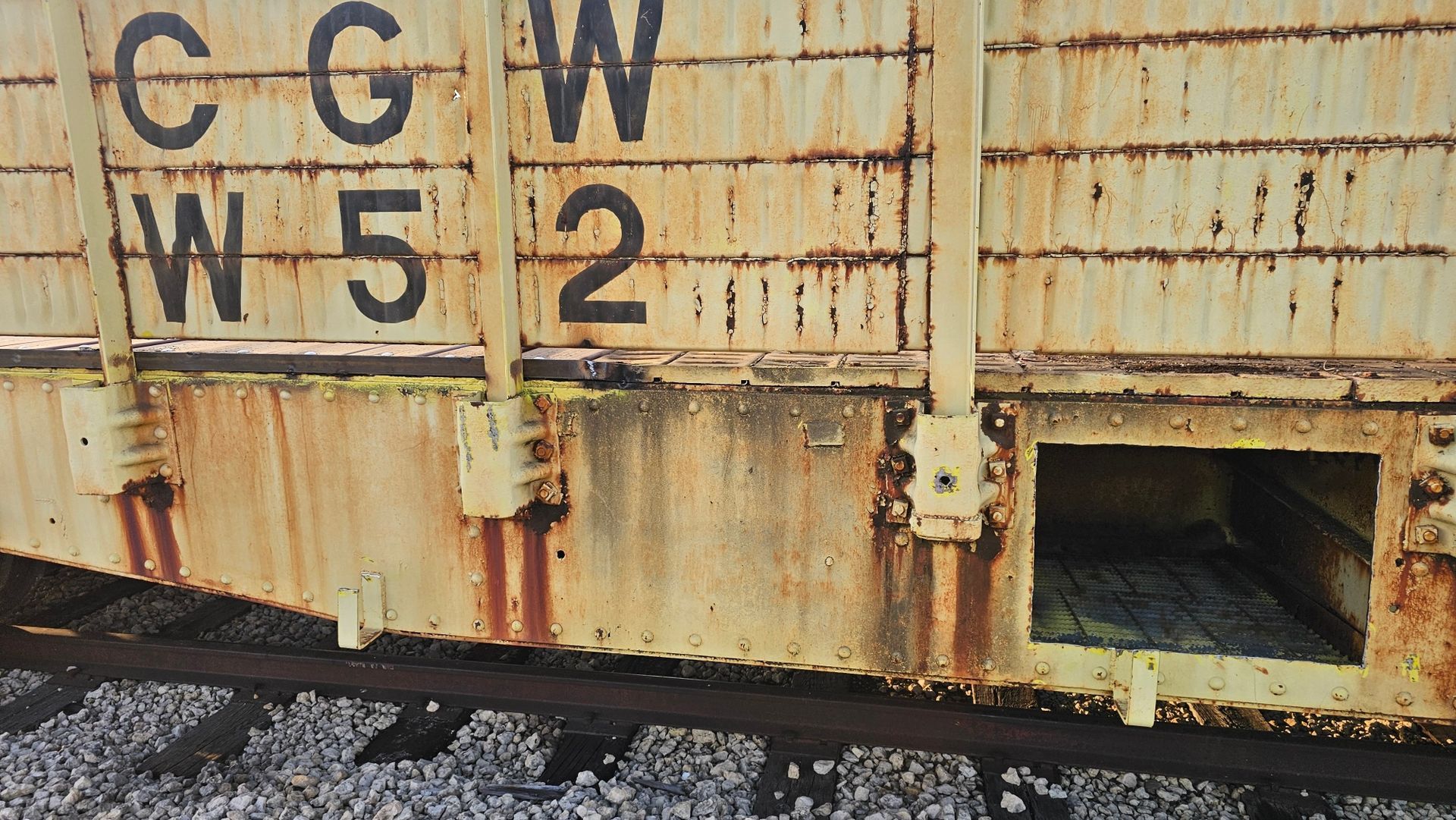 A rusty train car with the letters cgw on it