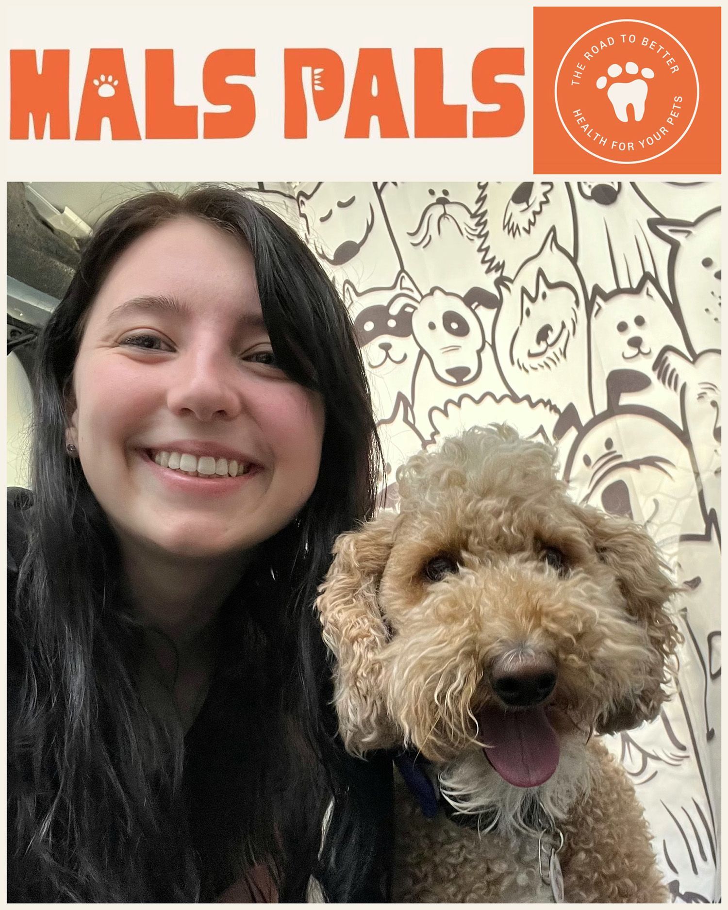 Woman with a smiling dog. They are against a dog-themed backdrop.