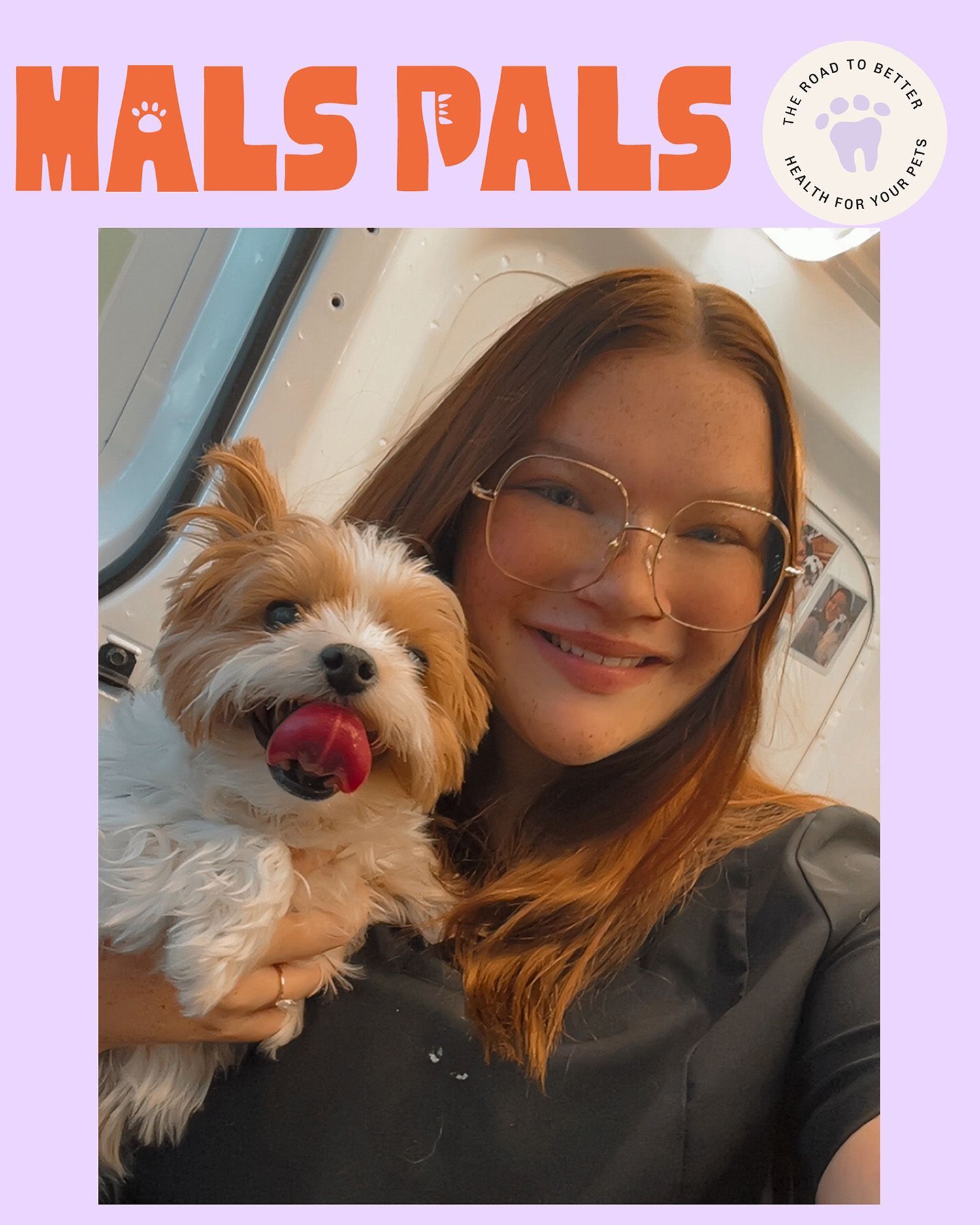 Woman with glasses smiling, holding a small dog with tongue out. 